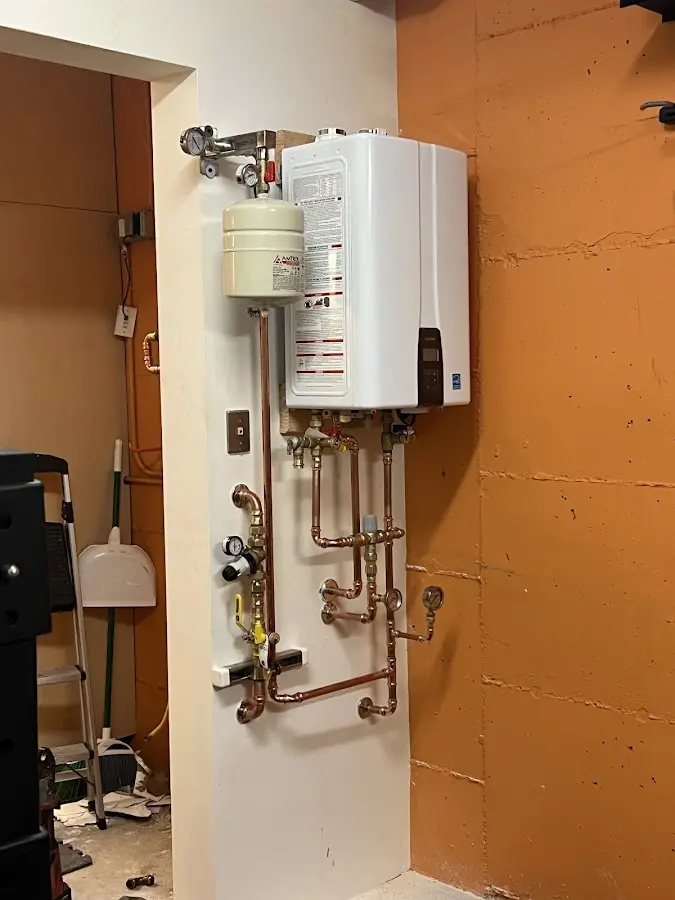 Plumbing technician inspecting water heater connections in Columbia